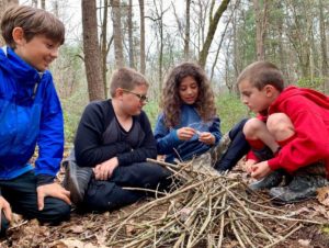 Children at forest school learning to start a campfire using a single match