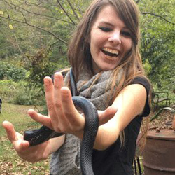Grace Upshaw having fun playing with a black snake