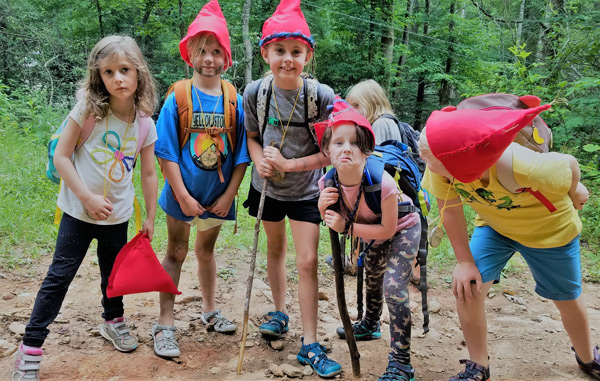 Summer day campers in Forest Gnome costumes playing at Asheville nature connection camp